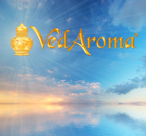 VedAroma text superimposed on a serene ocean sunset.