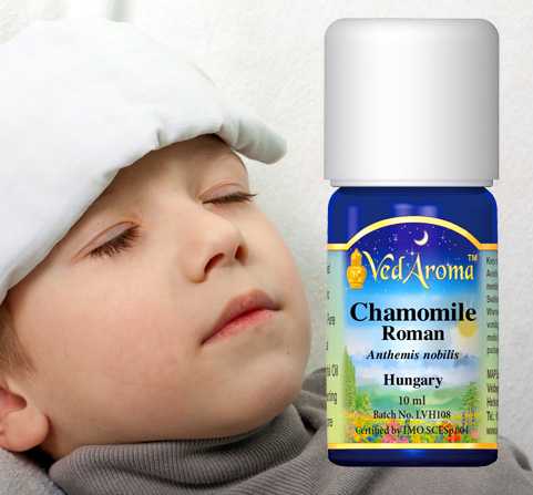A bottle of VedAroma Chamomile Roman essential oil is shown along with a photo of a very young child with a compress on his forehead.